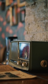 black and silver radio on brown wooden table