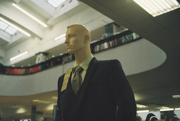 Gents' formal wear collection showcased on mannequins with elegant lighting