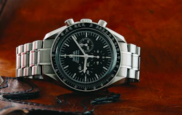 silver and black round analog watch