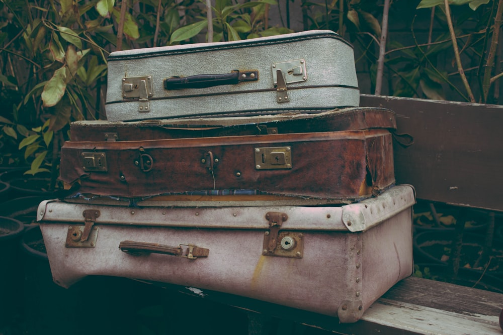 brown suitcase on white table