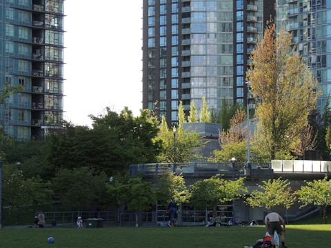 Families enjoying a community park near residential buildings.