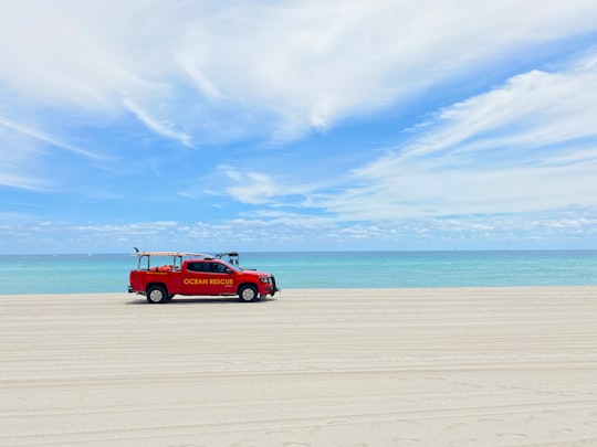red suv on beach during daytime in Sunny Isles Beach United States