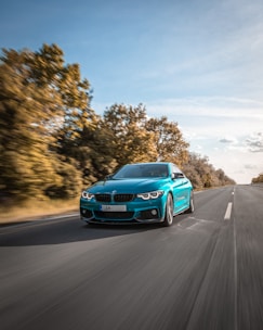 blue audi a 4 on road during daytime