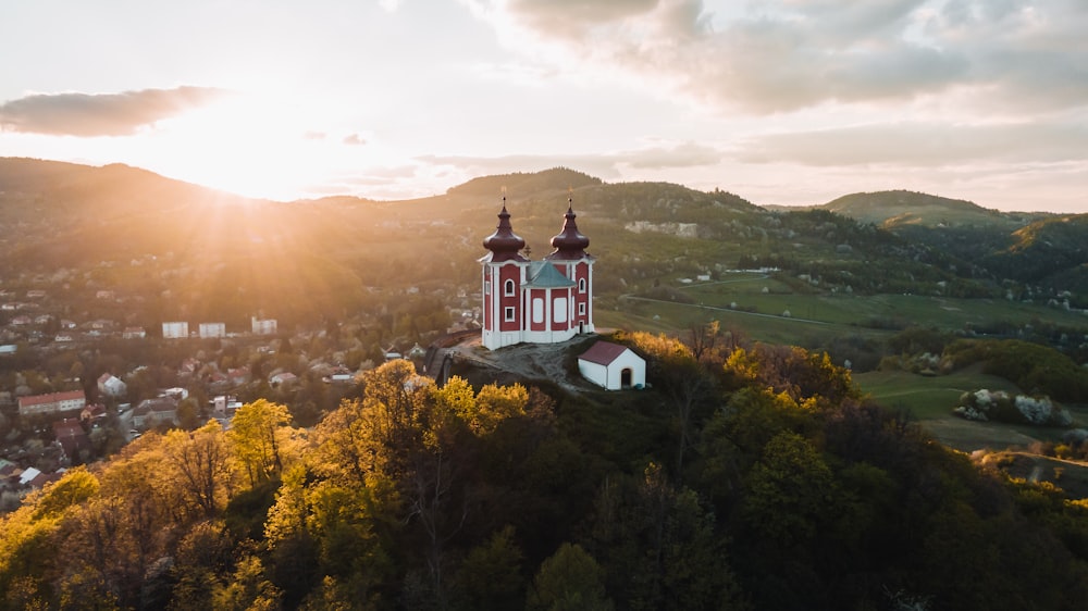 white and red concrete building on top of mountain during daytime