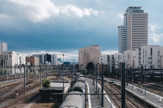 gray metal train rail near city buildings during daytime in Gare Vaugirard Montparnasse 3 France