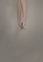 persons hand with pink manicure