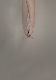 persons hand with pink manicure
