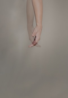 persons hand with pink manicure