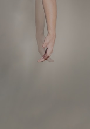 persons hand with pink manicure