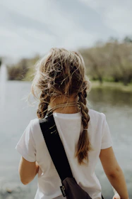 woman in white shirt with black sling bag