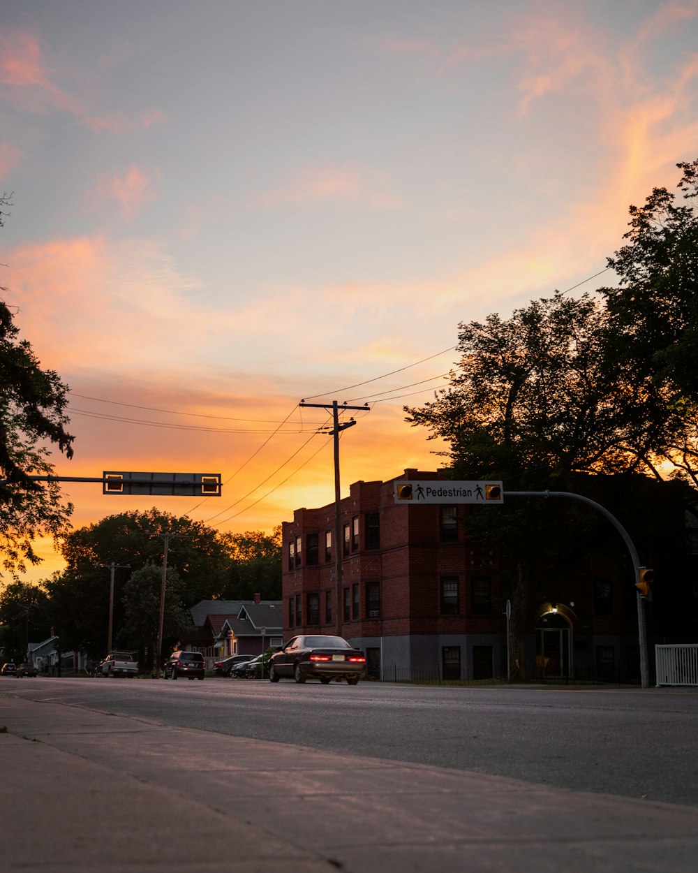 cars parked on side of the road during sunset