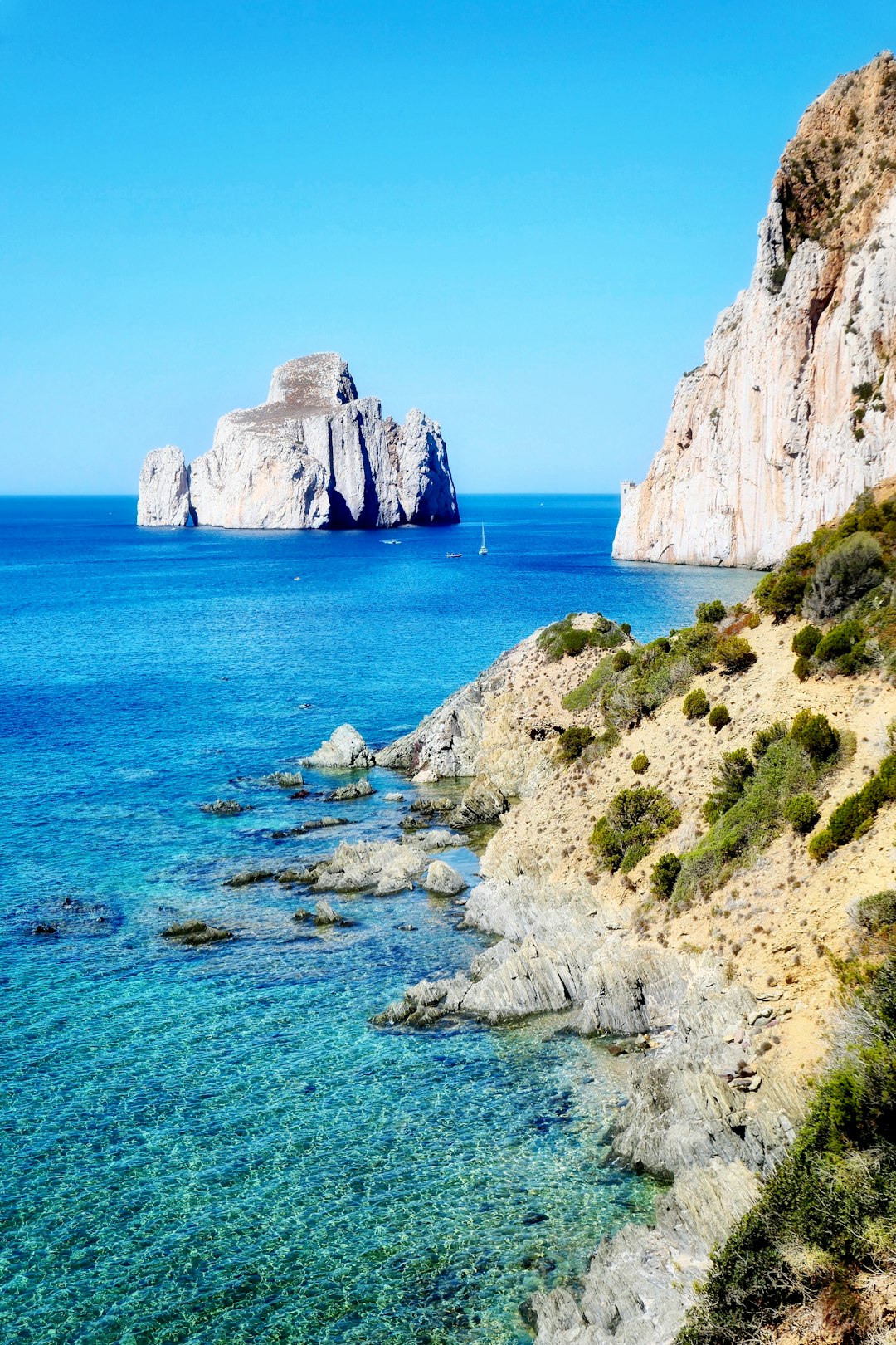 brown rock formation on blue sea under blue sky during daytime