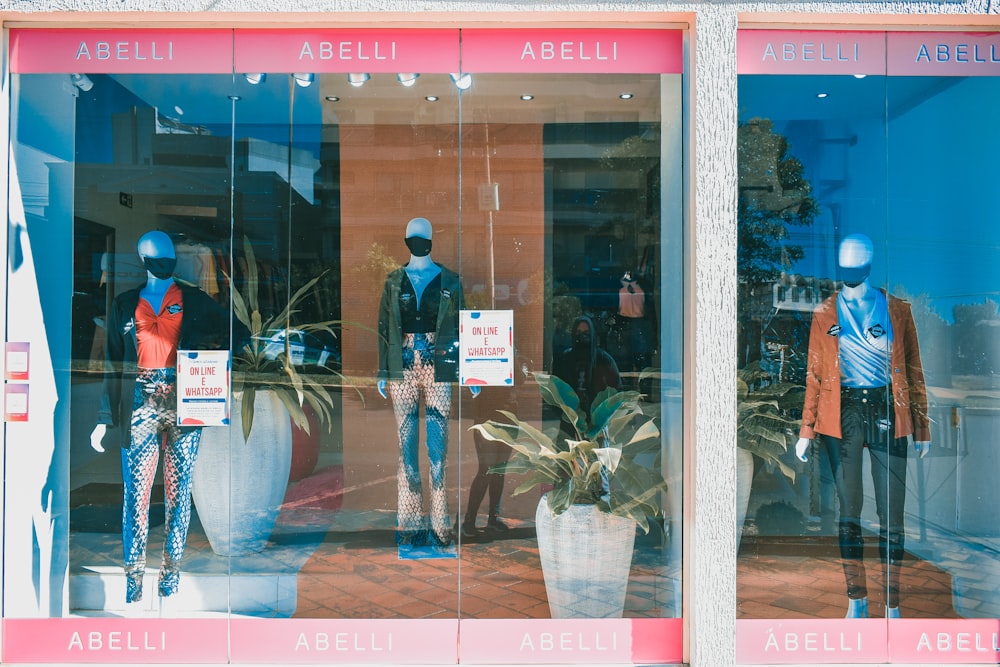 man in black jacket standing in front of store