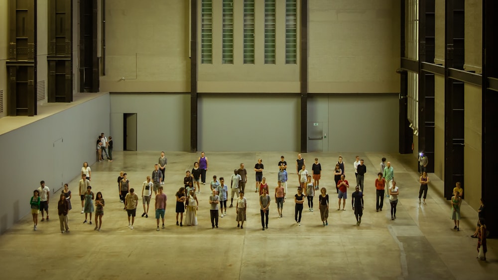 group of people standing on brown wooden floor