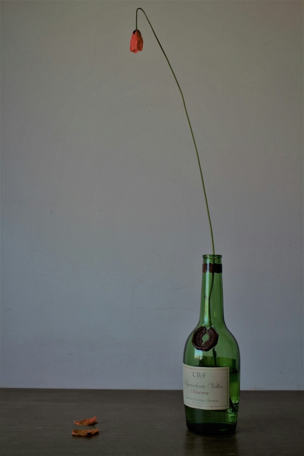 green glass bottle on white table