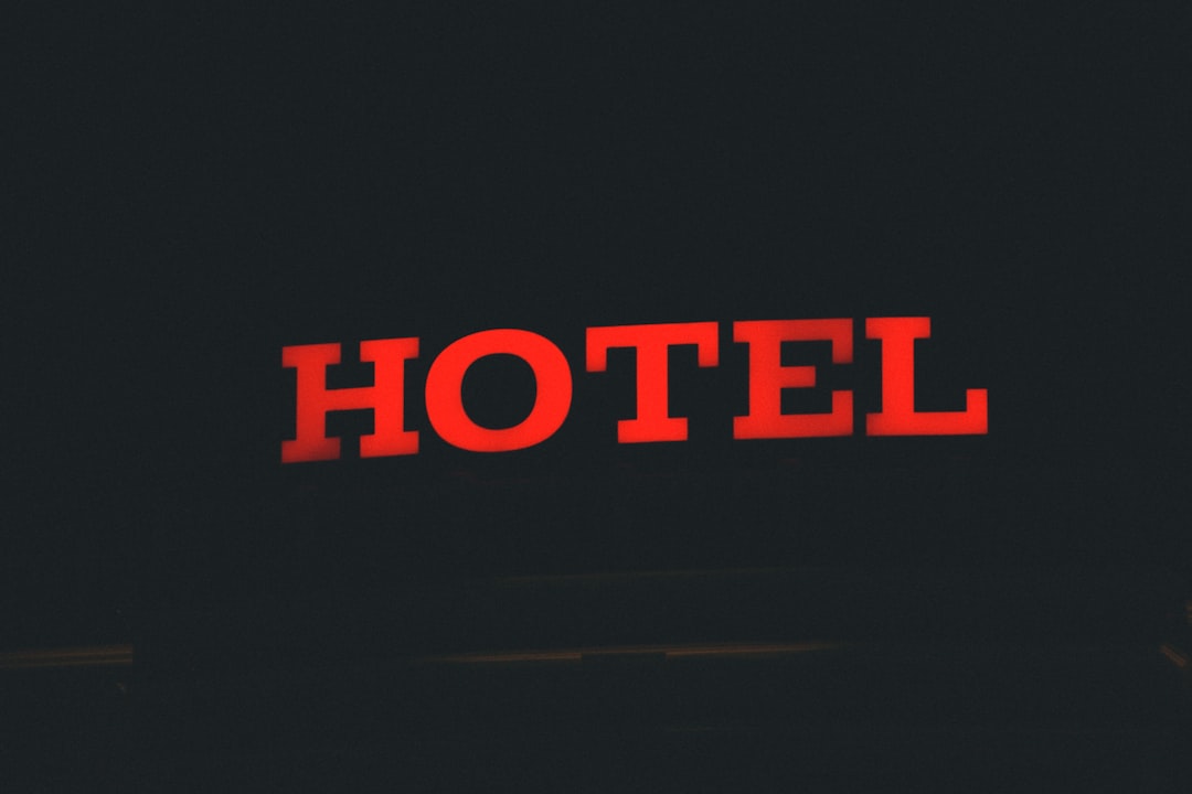 red and black open neon signage, hotel
