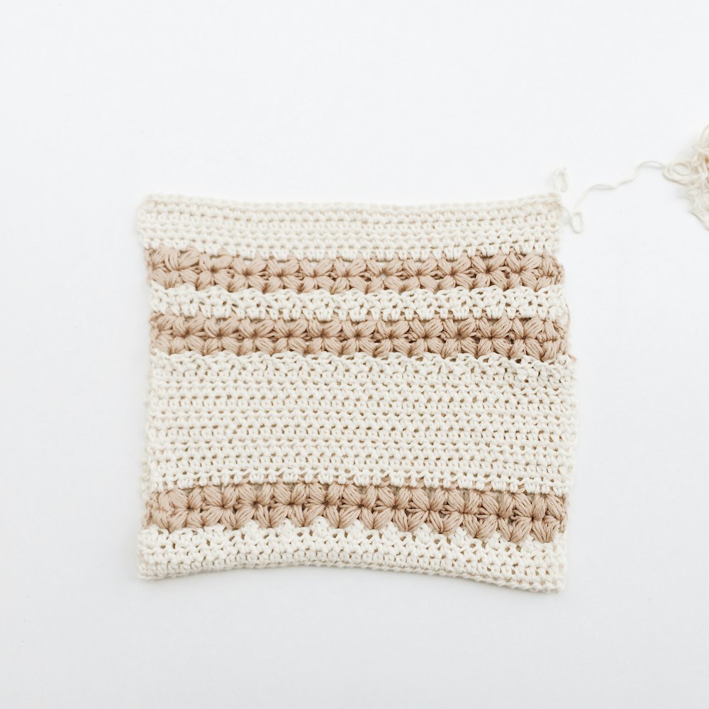 white and brown knit textile