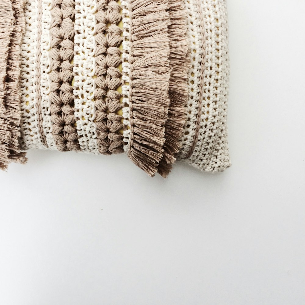 white and brown knit textile