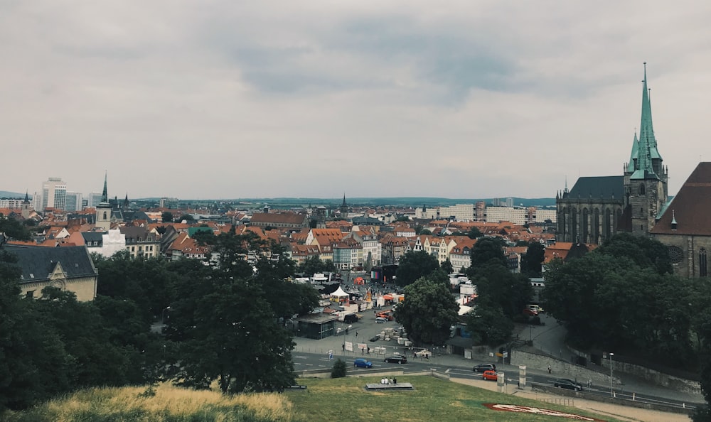 city with high rise buildings under white sky during daytime