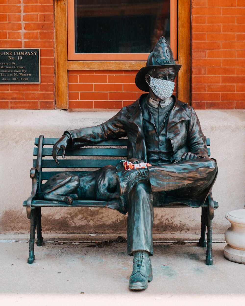 man in black leather jacket sitting on bench