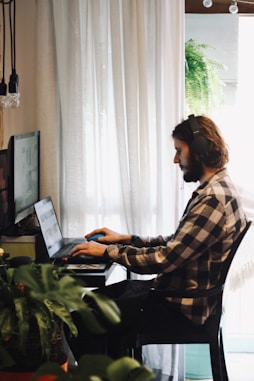 man that is improving google ads account on his laptop on a desk