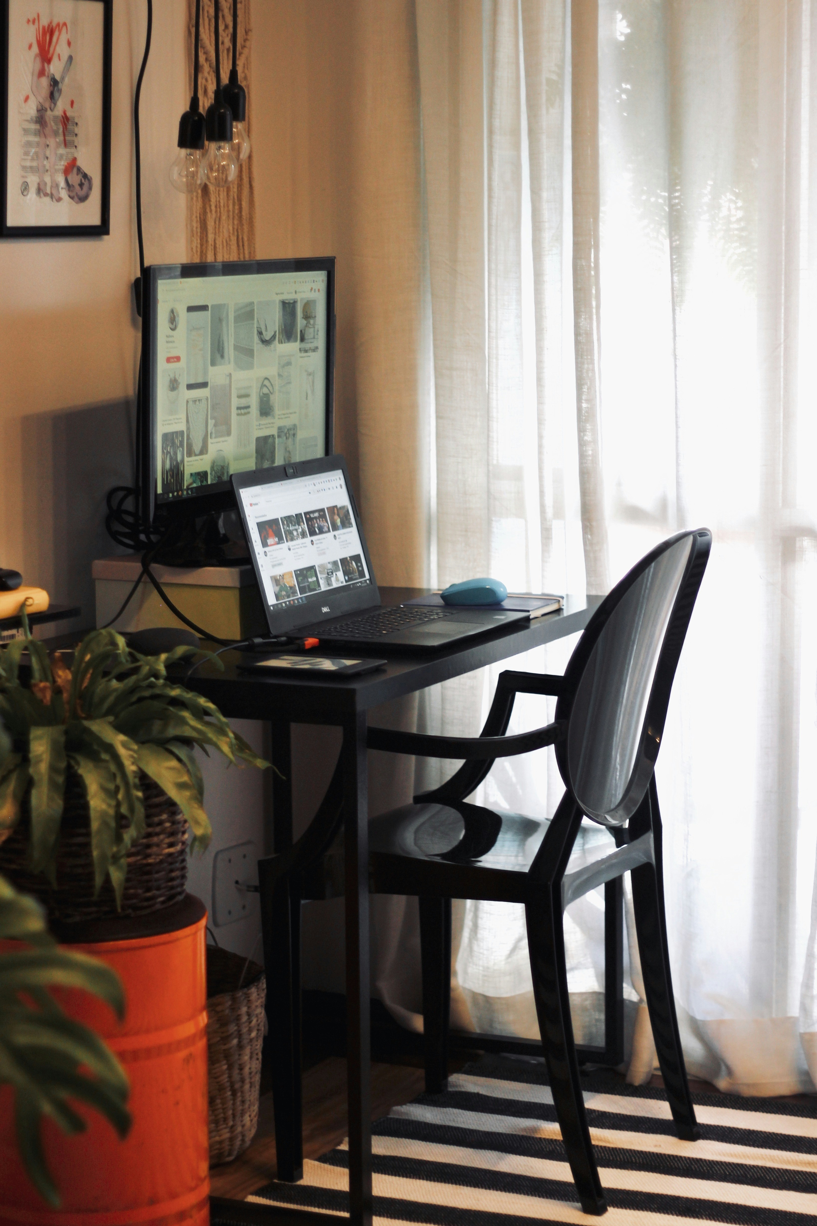 black laptop computer on black table