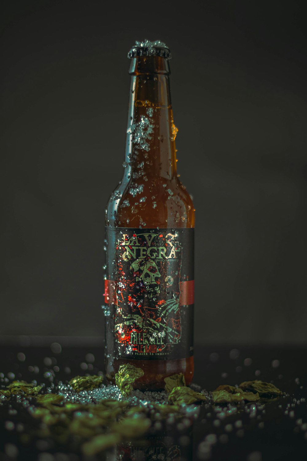 brown glass bottle on black table