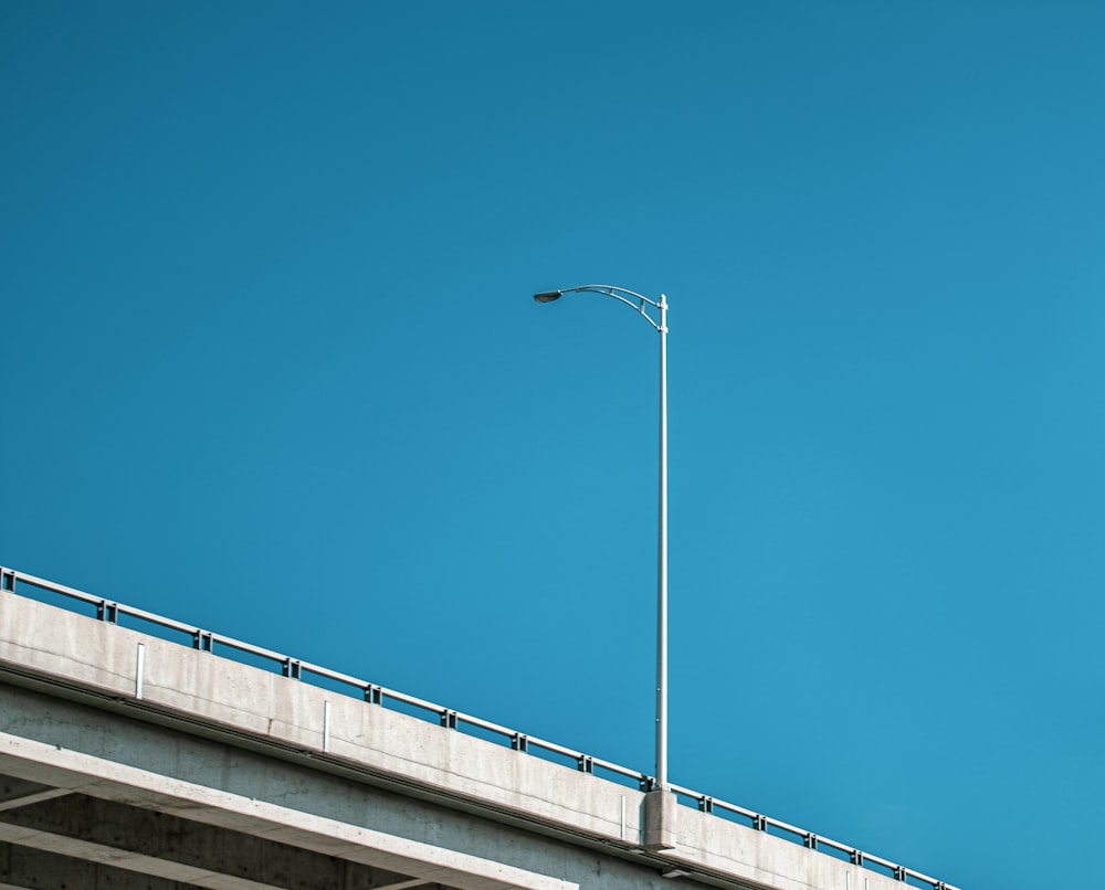 white street light under blue sky during daytime