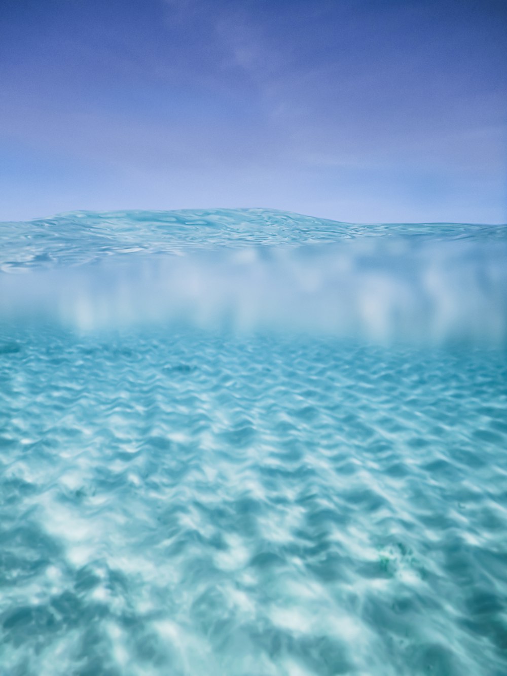 blue body of water under blue sky during daytime