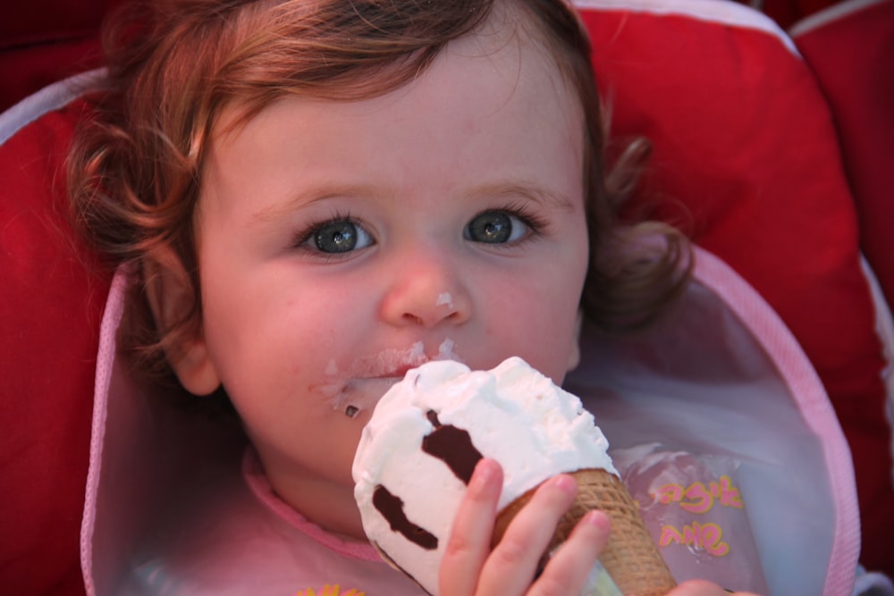girl in pink shirt eating ice cream