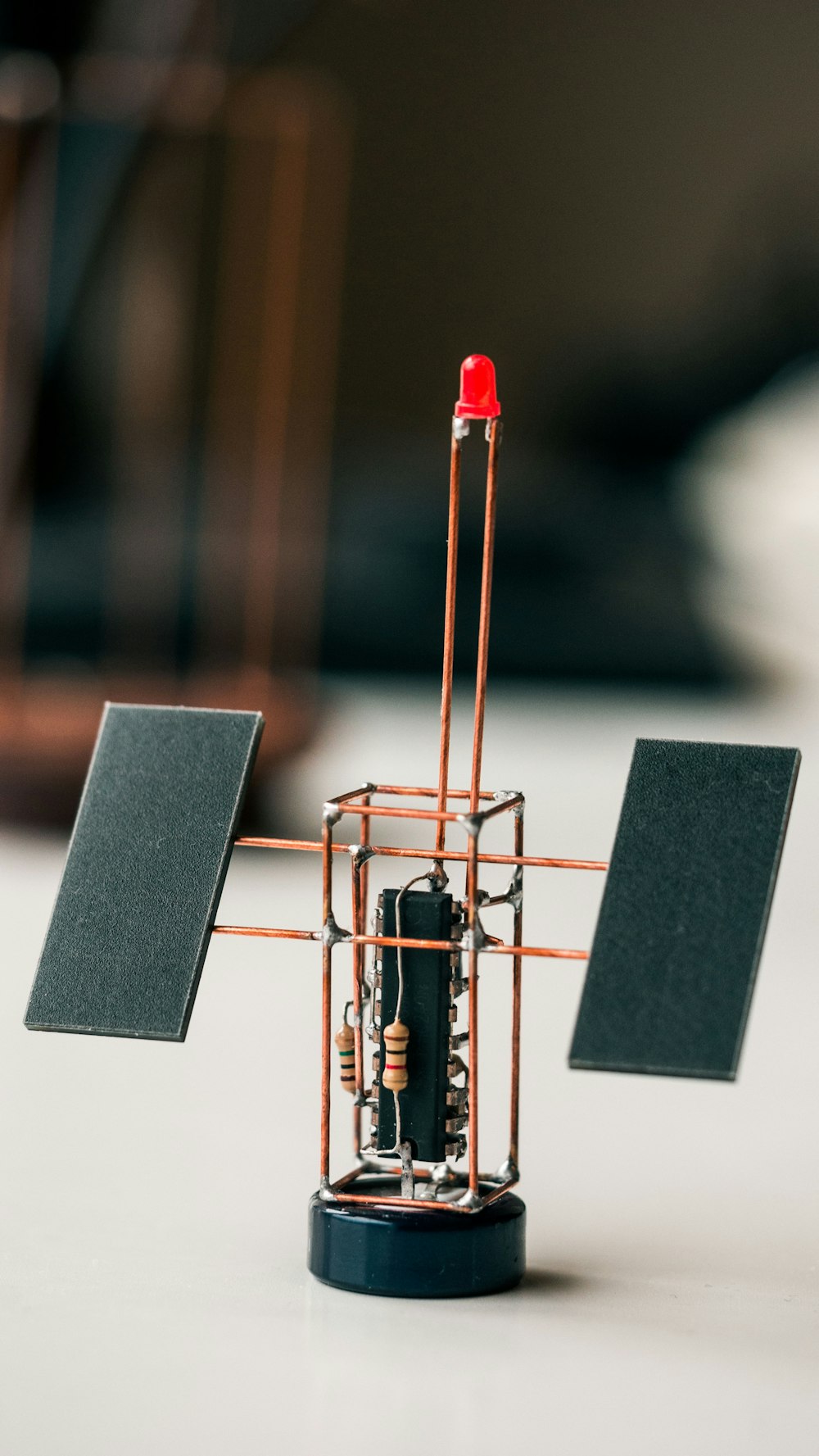 black and silver speaker with red and gold stand