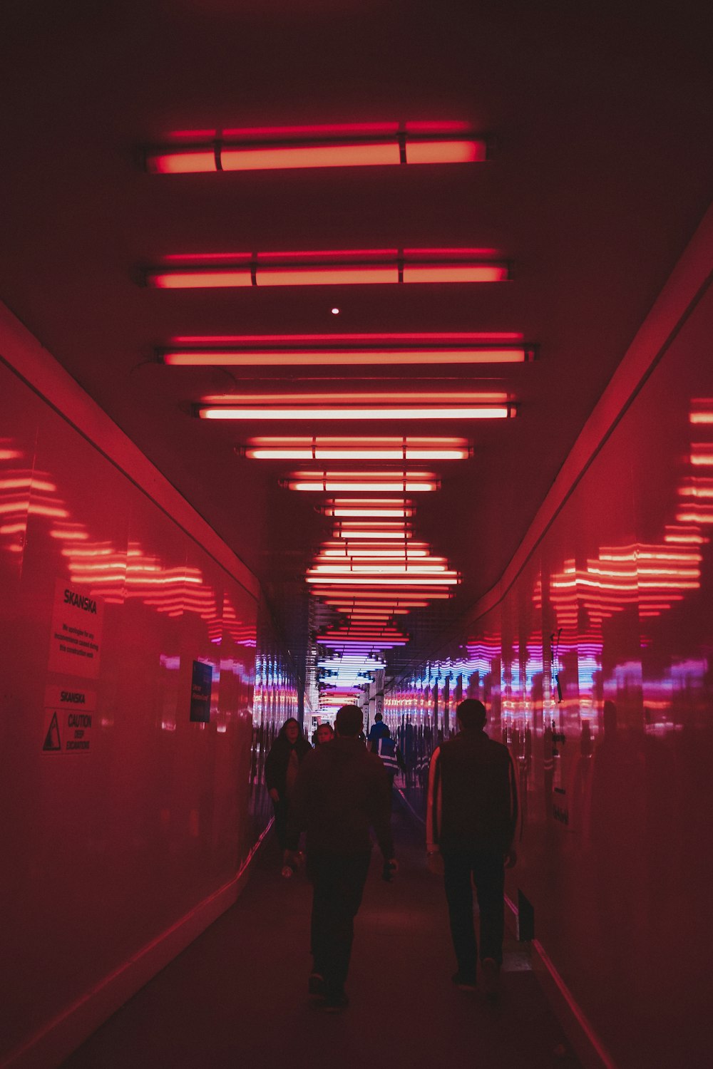 people walking on hallway during night time