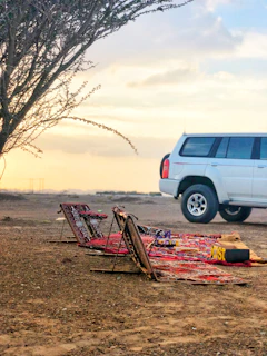 A quiet, authentic scene of a family sharing a picnic bathed in soft sand tones.