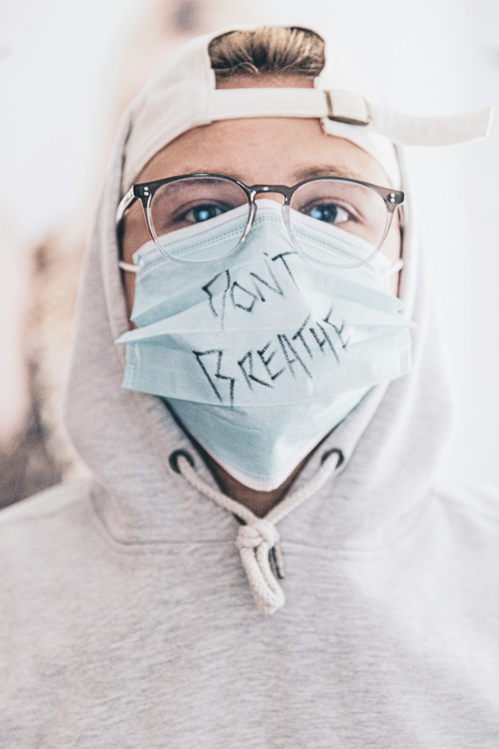 man in white hoodie with blue face paint