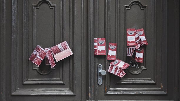 red and white plastic packs on brown wooden door