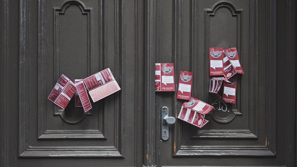 red and white plastic packs on brown wooden door