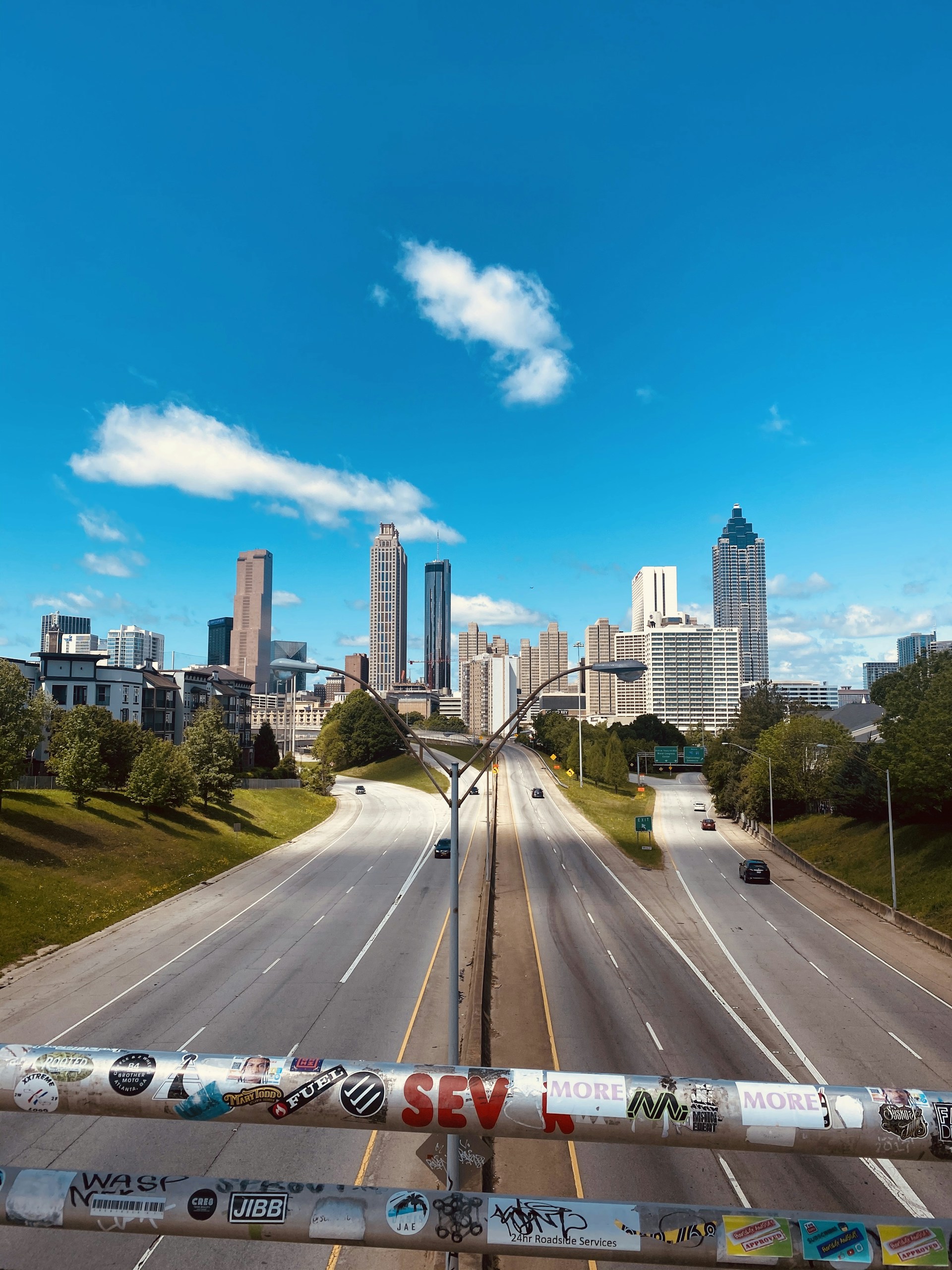 cars on road near city buildings during daytime