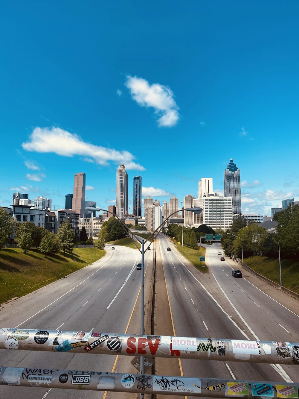 cars on road near city buildings during daytime