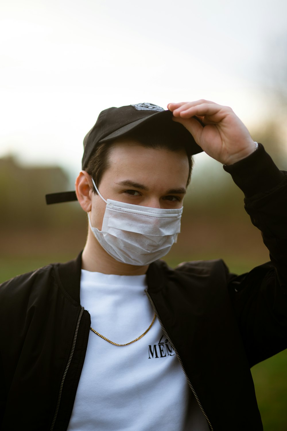 man in black jacket wearing white face mask