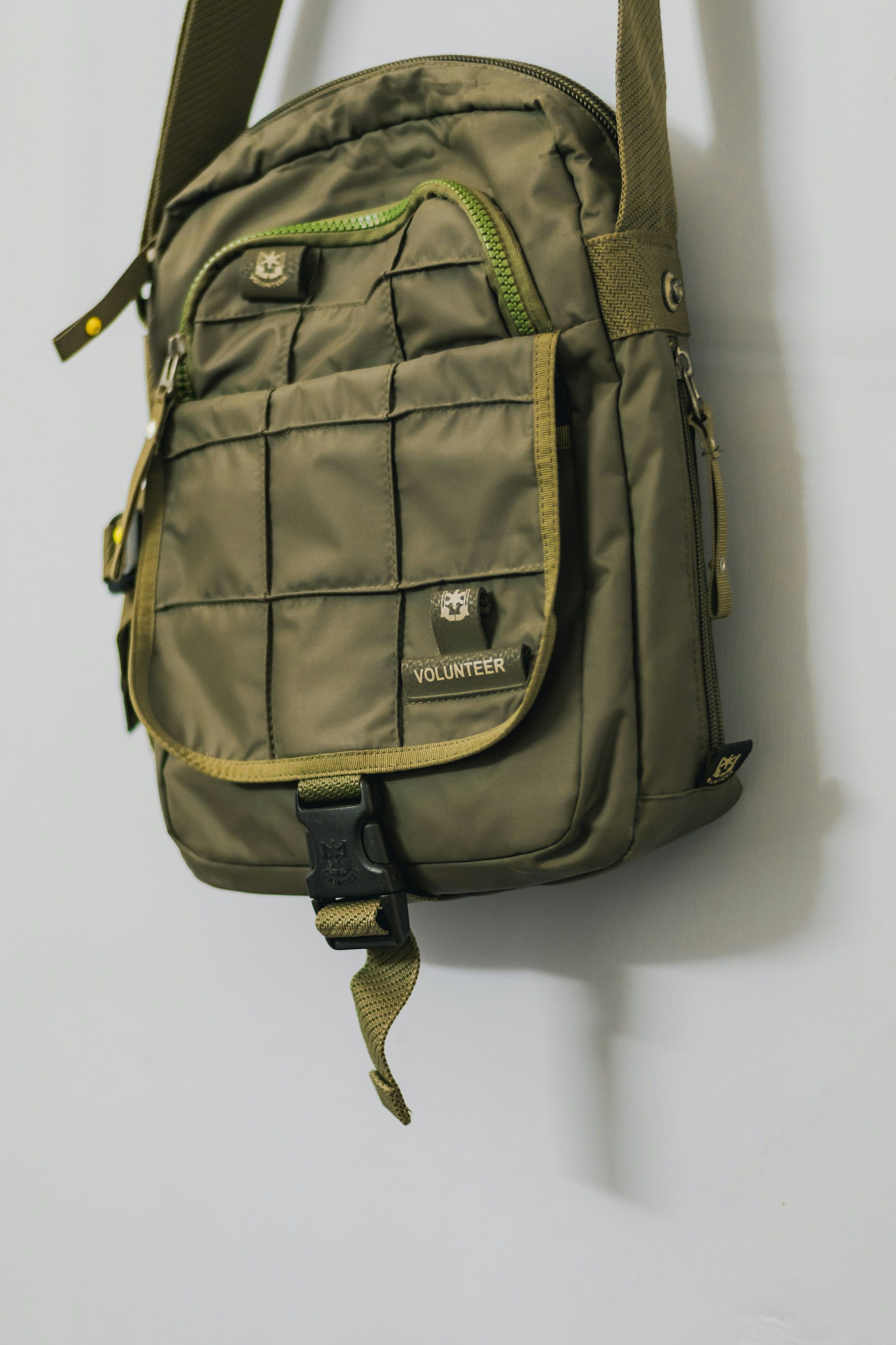 green backpack on white table