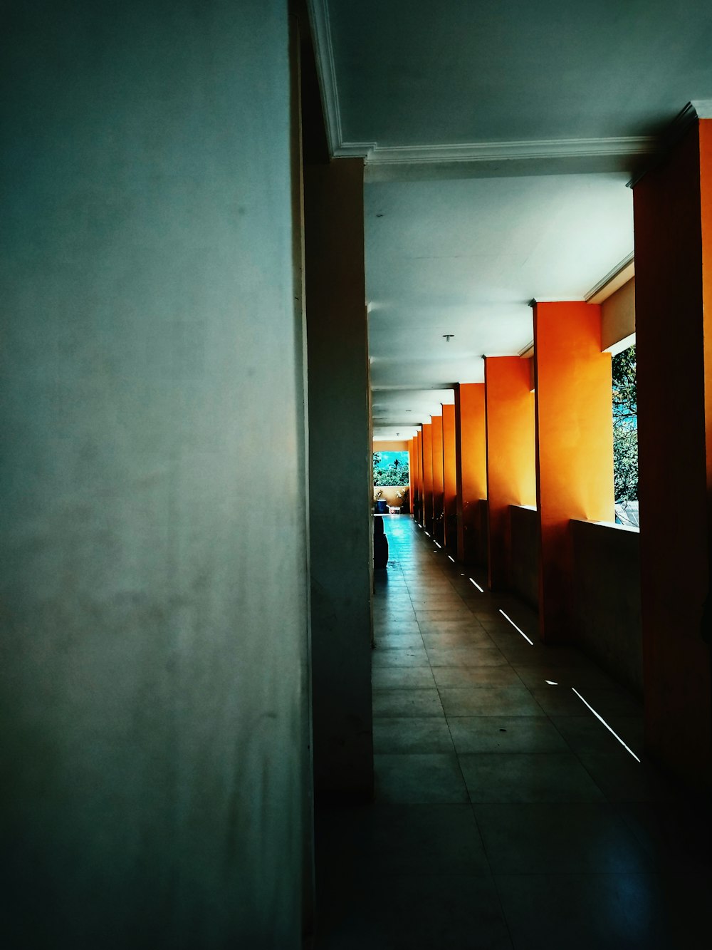 white hallway with orange doors