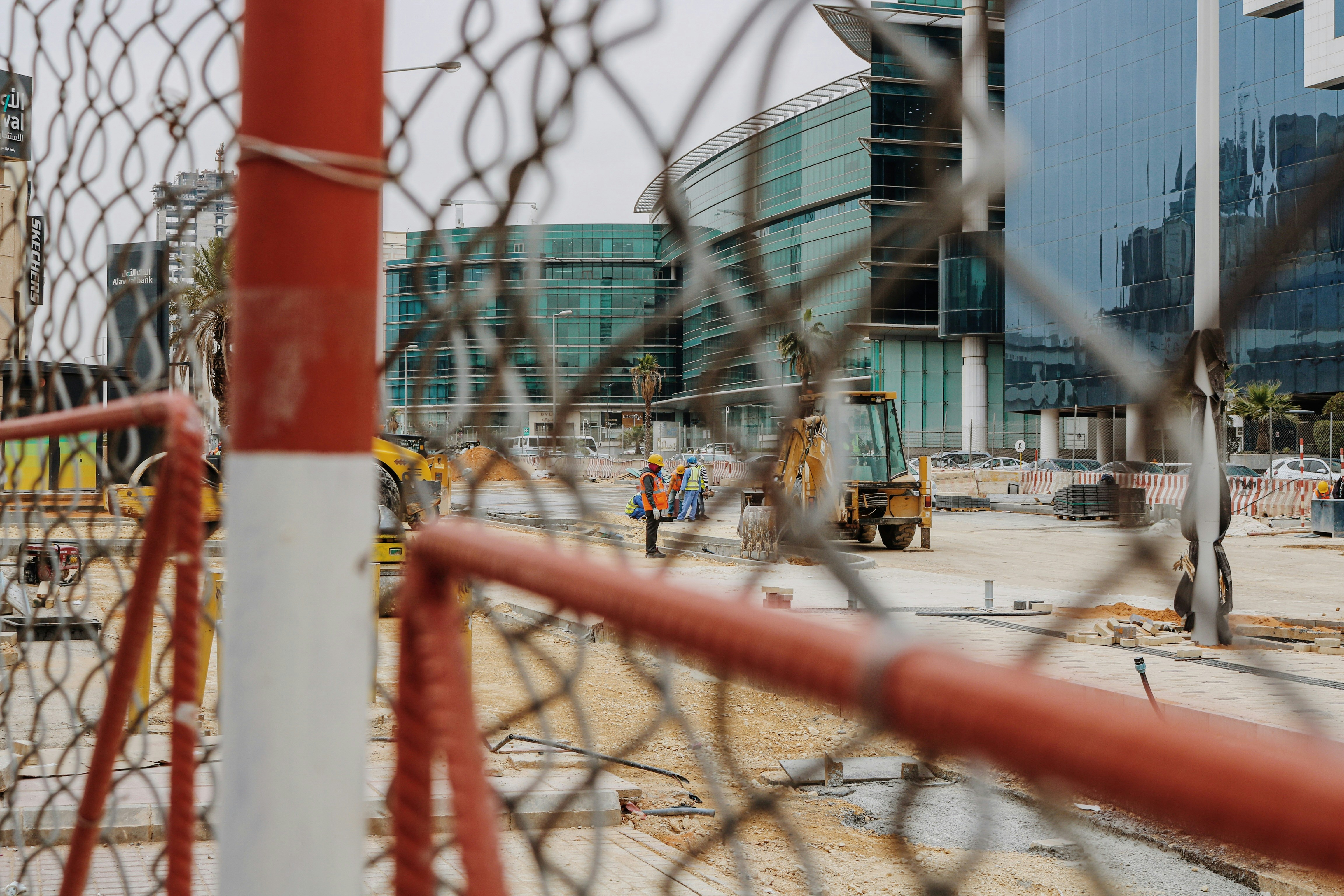 Active construction site with workers building modern home structure and quality control