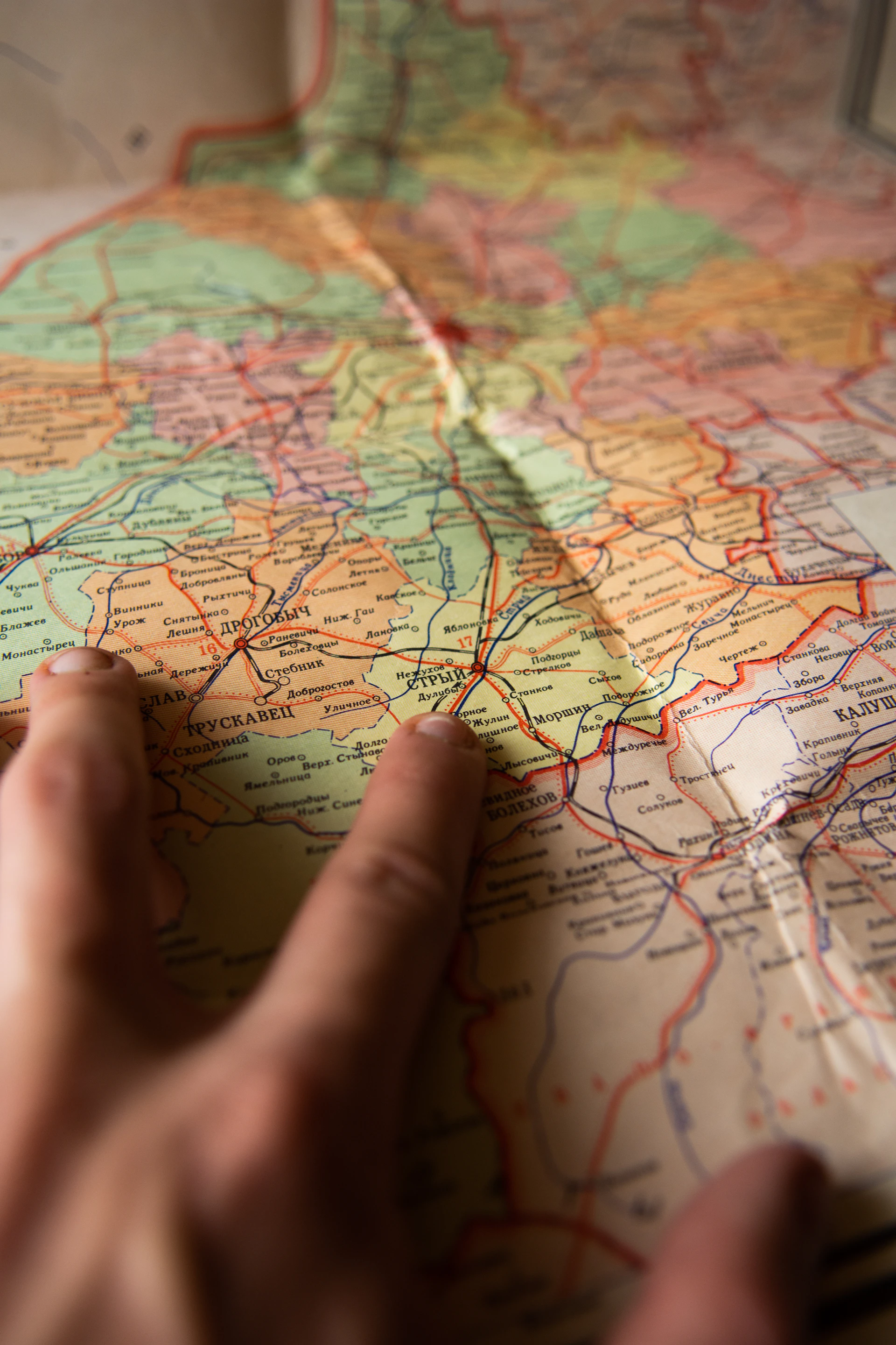 persons left hand on map