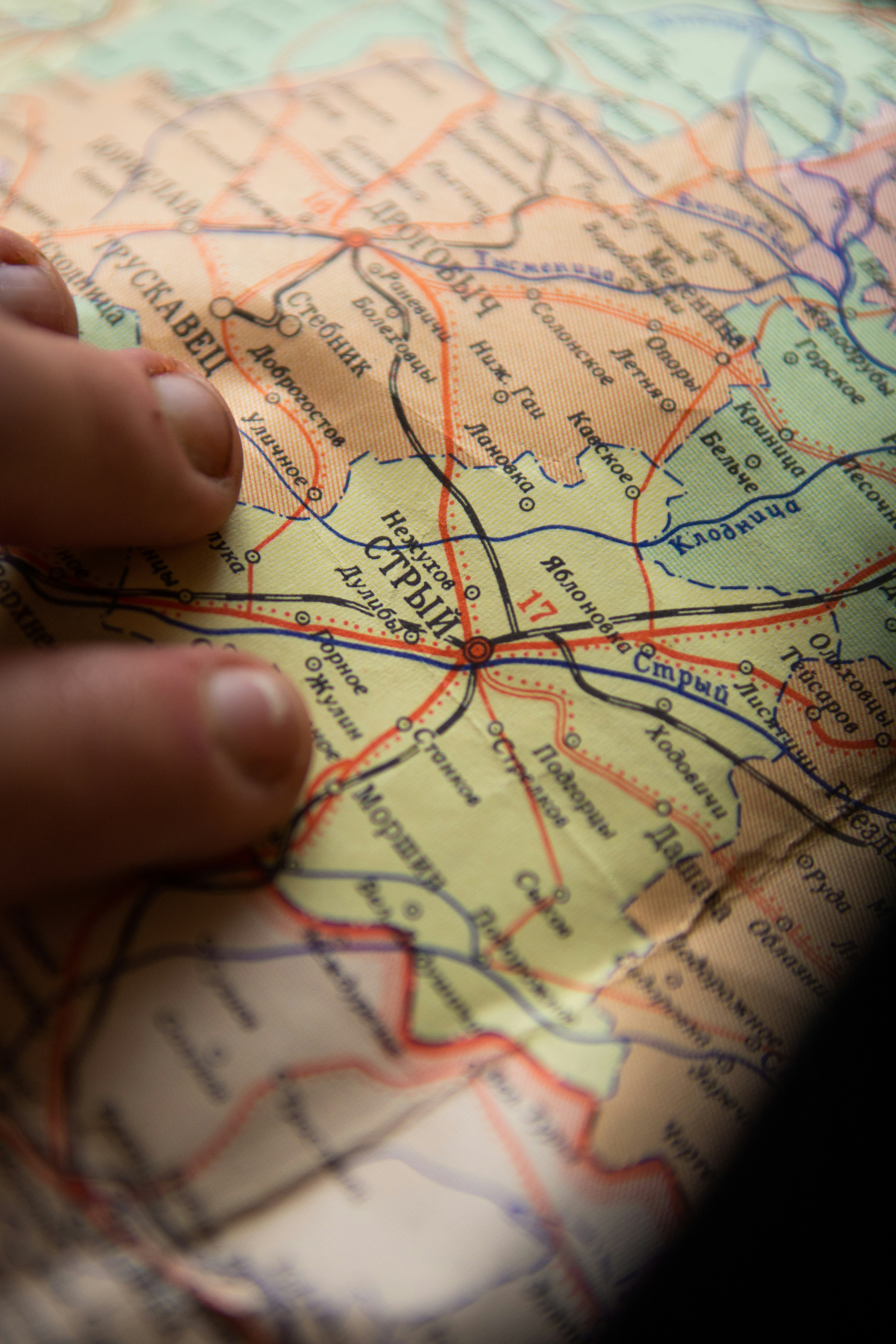 person holding red and white textile