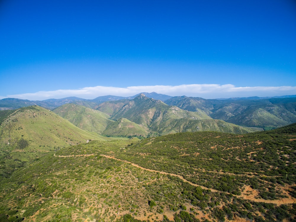 green and brown mountains under blue sky during daytime