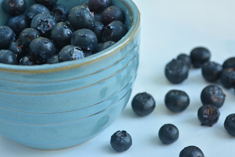 black berries in blue ceramic bowl