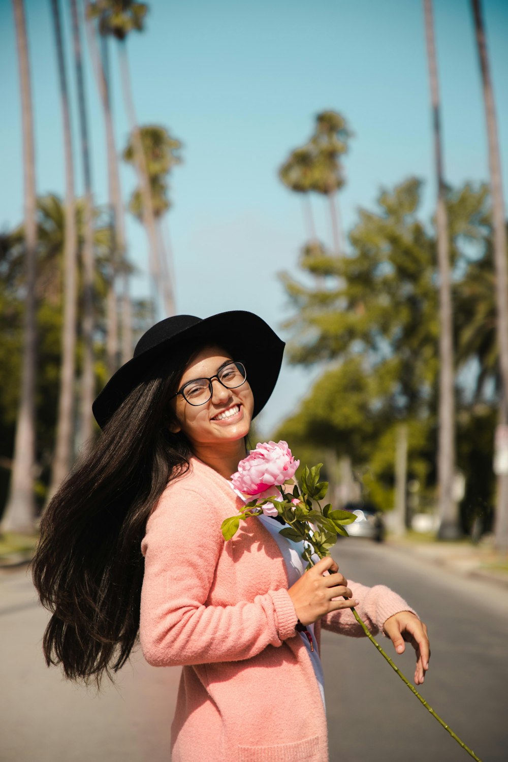 woman in pink dress holding bouquet of flowers