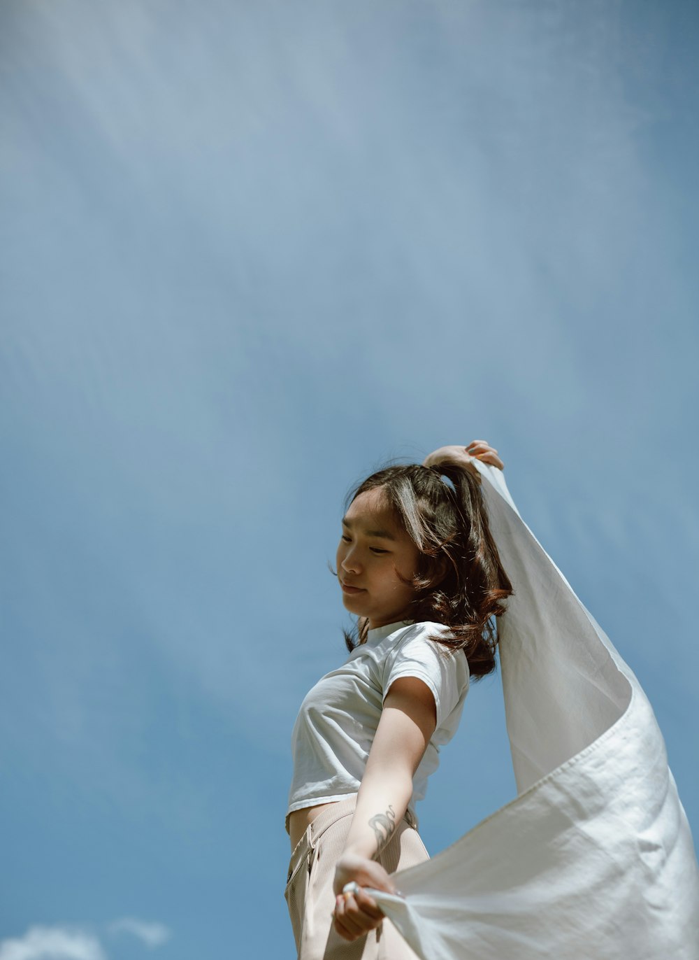 woman in white t-shirt and white skirt