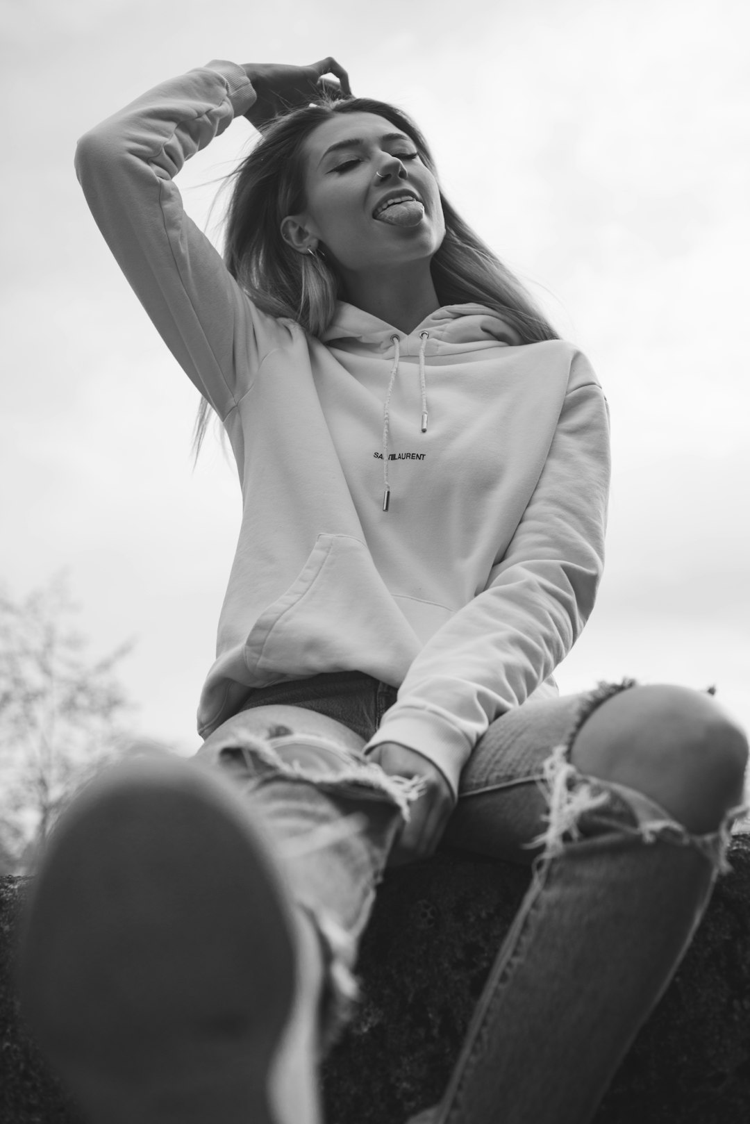 grayscale photo of woman in hoodie and jeans