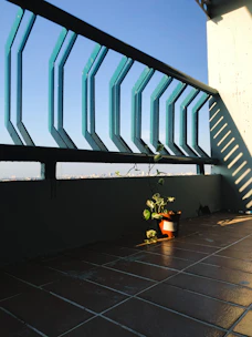 A compact balcony solar panel kit neatly installed on a small urban balcony with sunlight filtering through.